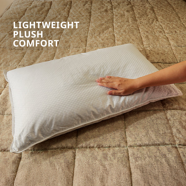 White pillow on a textured brown surface with 'Lightweight Plush Comfort' text.