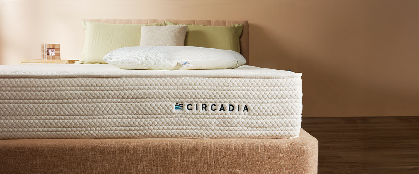 Circadia mattress on a bed with pillows against a beige wall