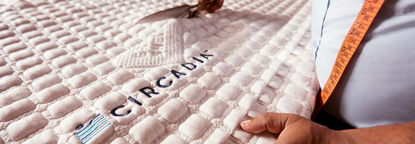 Mattress with 'Circadia' branding and a hand holding a measuring tape.