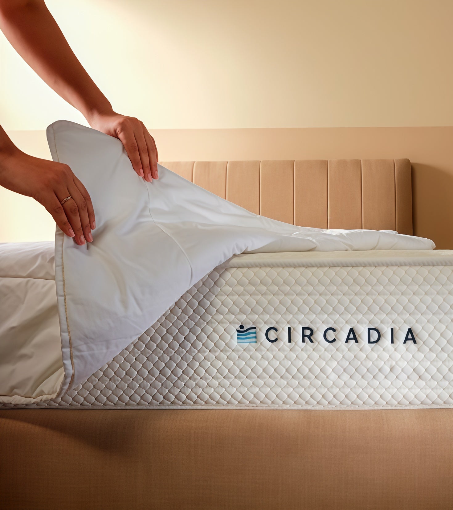 Person adjusting a mattress cover on a Circadia branded mattress in a bedroom setting.