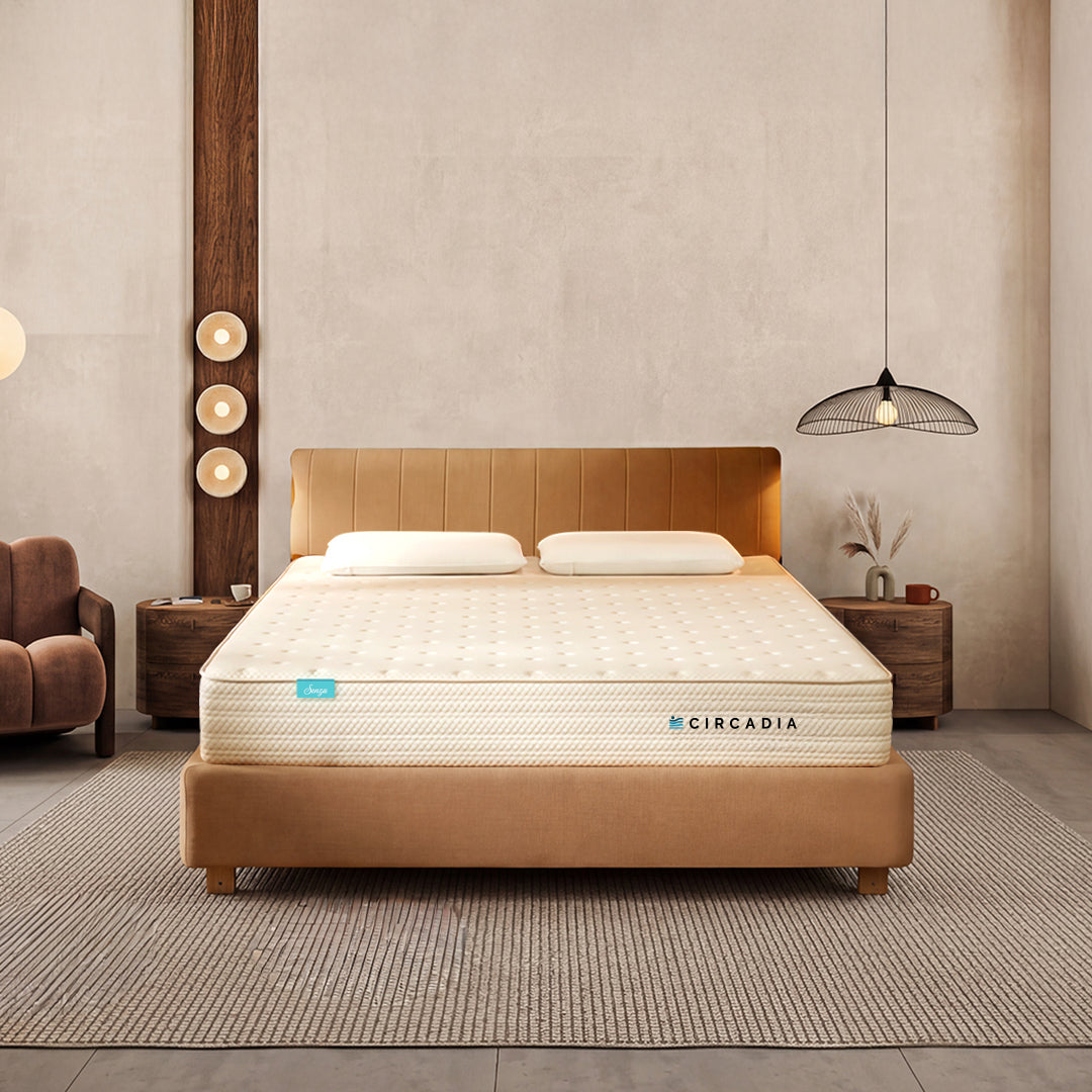 Beige mattress on a bed frame with 'Circadia' branding in a bedroom setting.