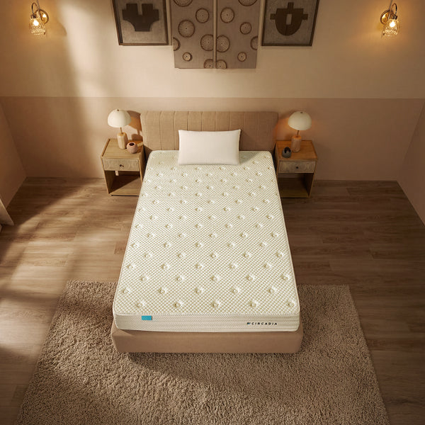 Mattress on a bed in a bedroom setting with warm lighting