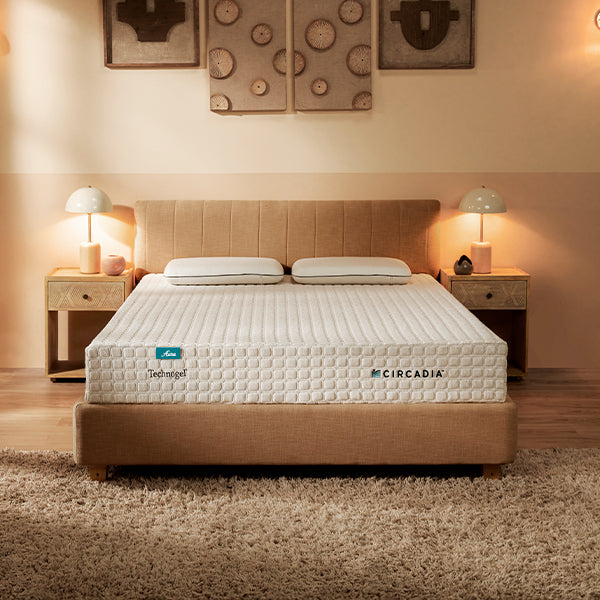 Bedroom with a bed featuring a Circadia mattress, flanked by nightstands with lamps.