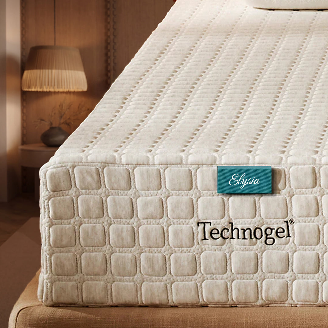 Beige mattress with 'Elysia Technogel' label in a bedroom setting