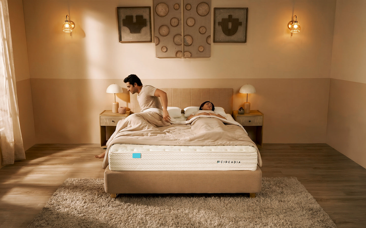 Man and woman lying on a bed with a MicraMeda mattress in a bedroom setting.