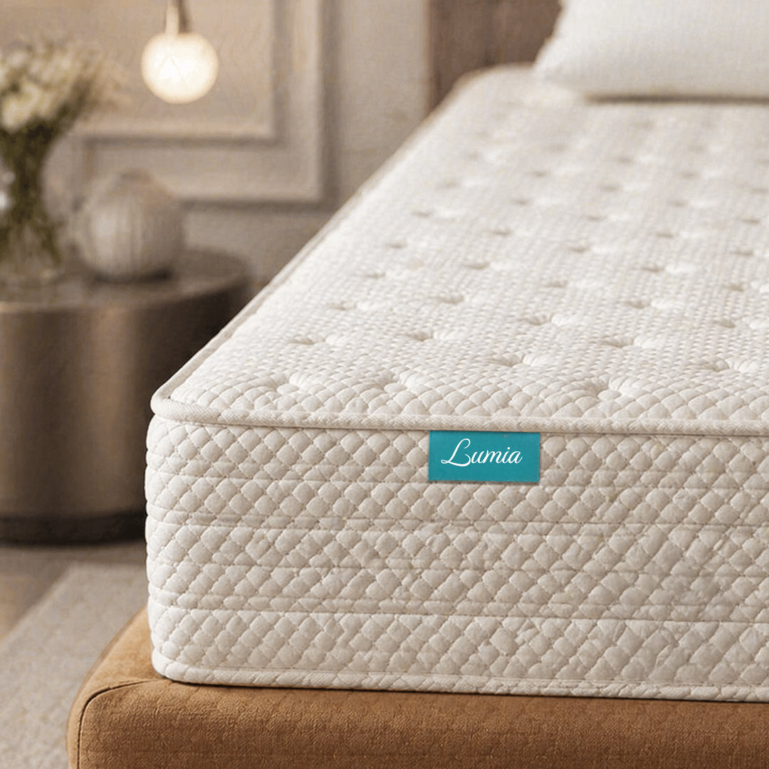 Beige mattress with 'Lumia' label in a bedroom setting