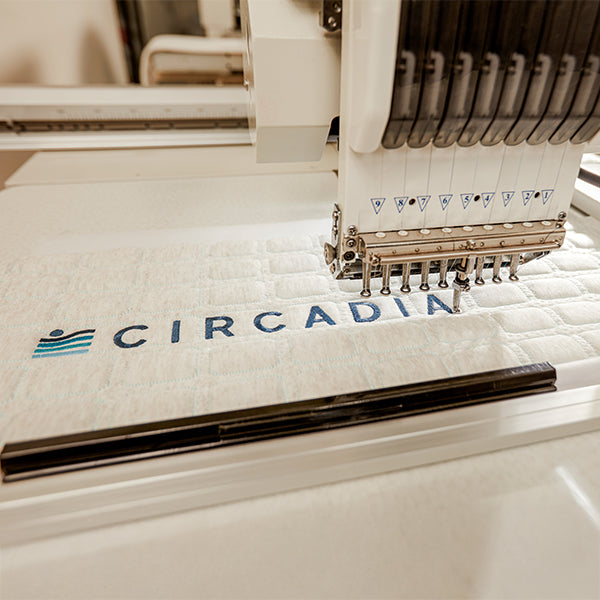 Embroidery machine with 'Circadia' branding on a piece of fabric.