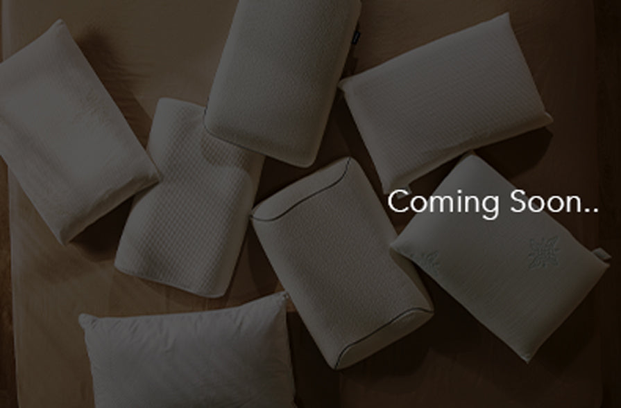 White pillows on a wooden surface with 'Coming Soon' text overlay