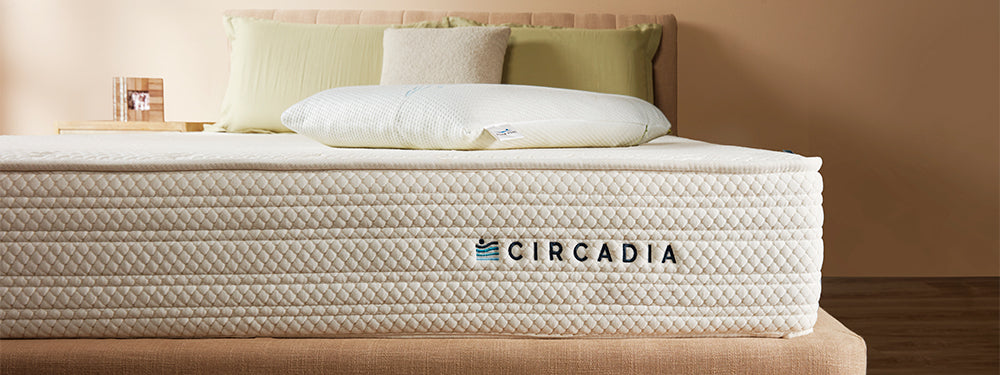 Circadia mattress on a bed with pillows against a beige wall