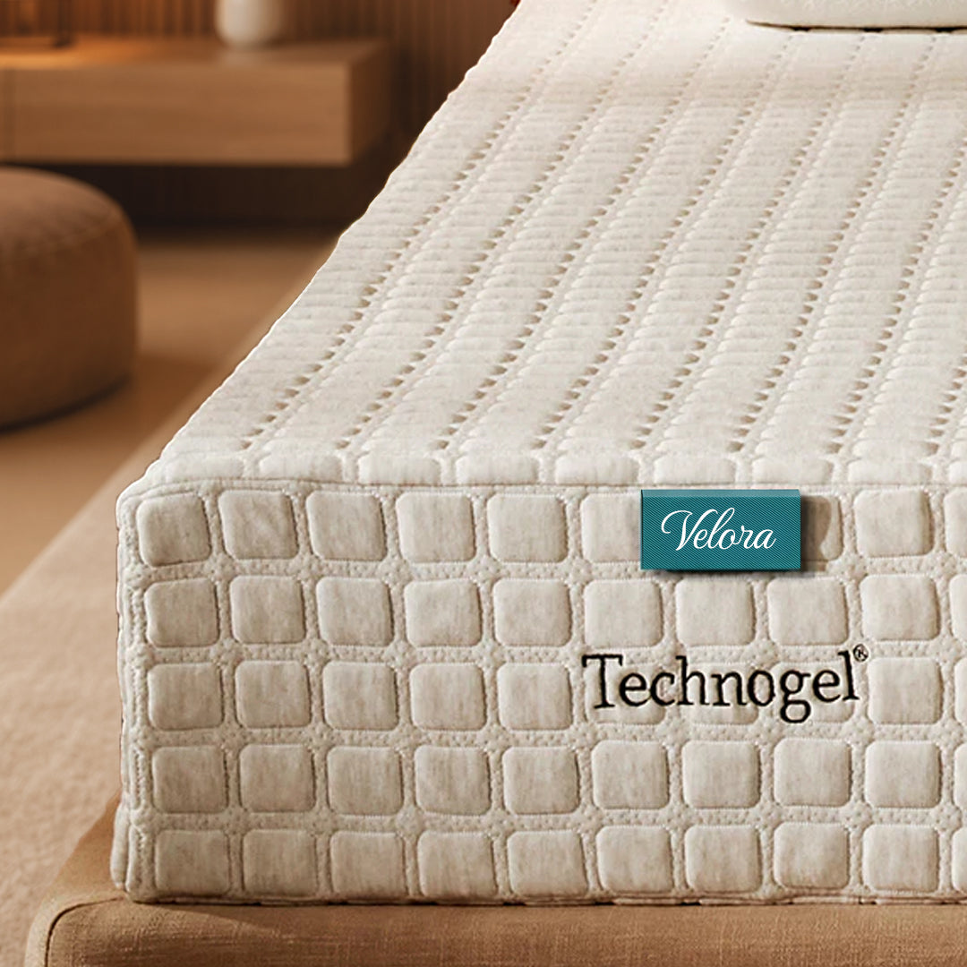 Mattress with Velora Technogel label on a bed in a bedroom setting