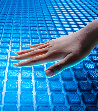 Hand touching a blue textured surface